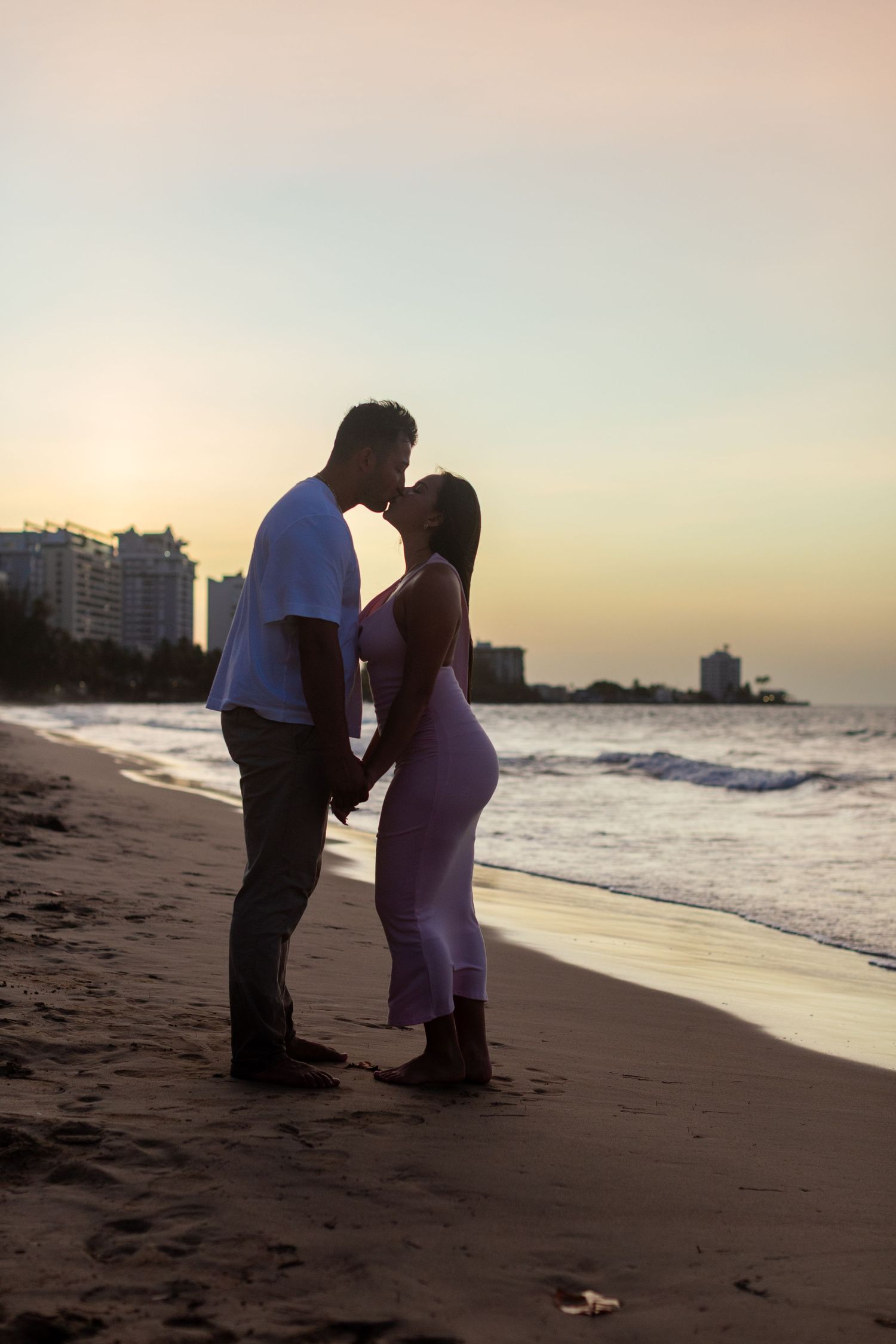 Sunset silhouette couples portrait at the beach in Isla Verde, Carolina, Puerto Rico.