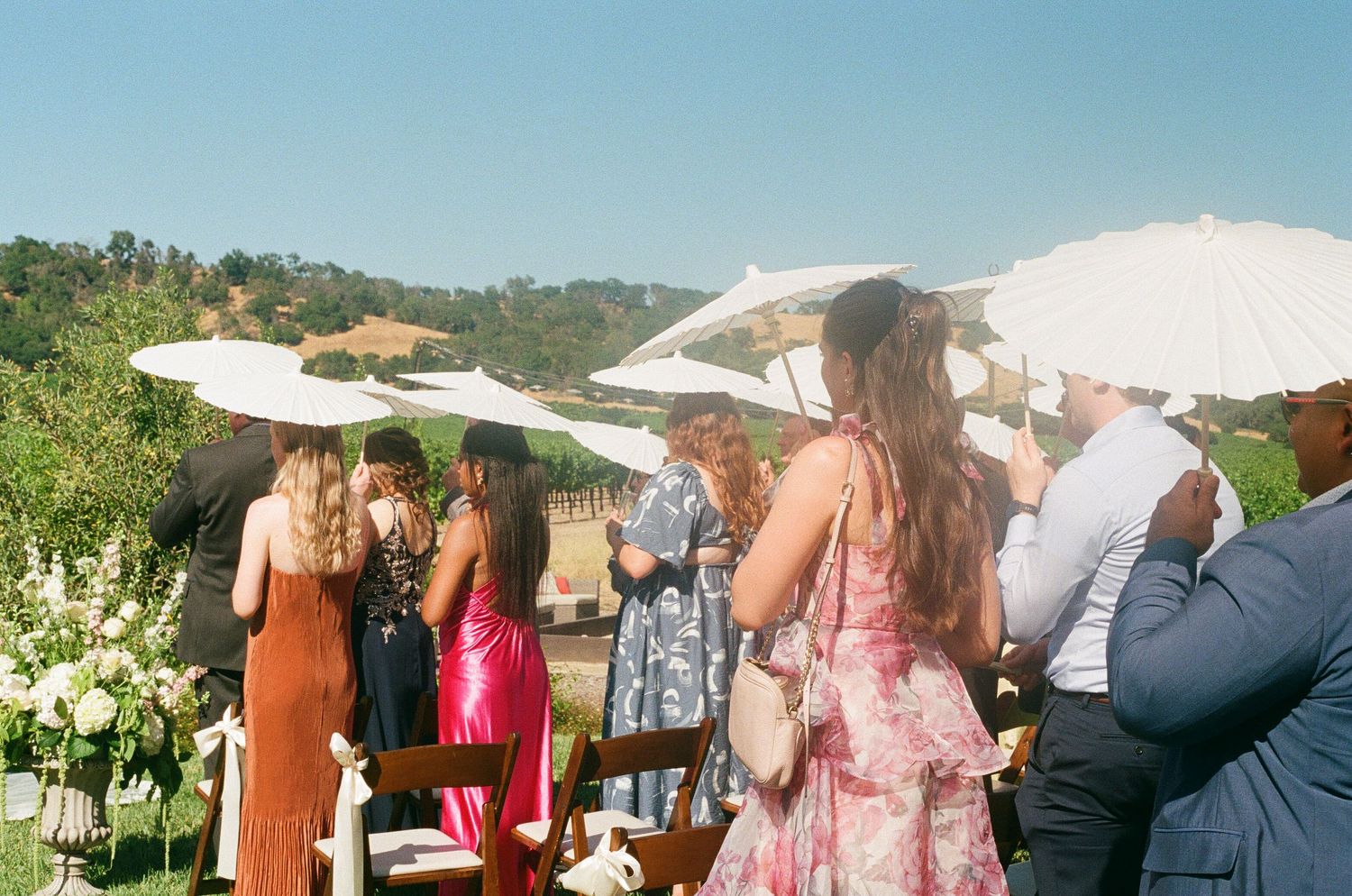 overhead photograph of a wedding dinner in Switzerland, couple leans in to kiss as they celebrate after their wedding ceremony