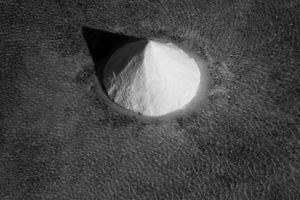 Close-up view of crystallized salt formations in dark water.
