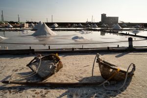Traditional wooden boats and equipment used for salt harvesting operations.