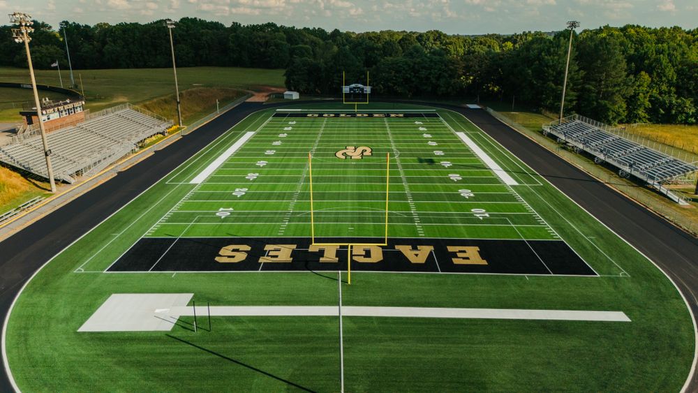 Birds eye view of an empty football stadium with EAGLES text painted in the endzone.