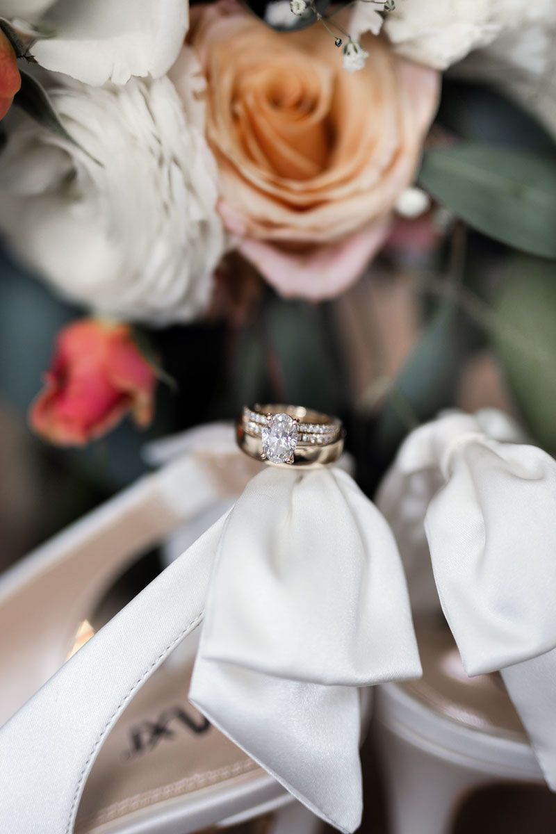 Romantic Edmonton wedding details featuring wedding rings on shoes.