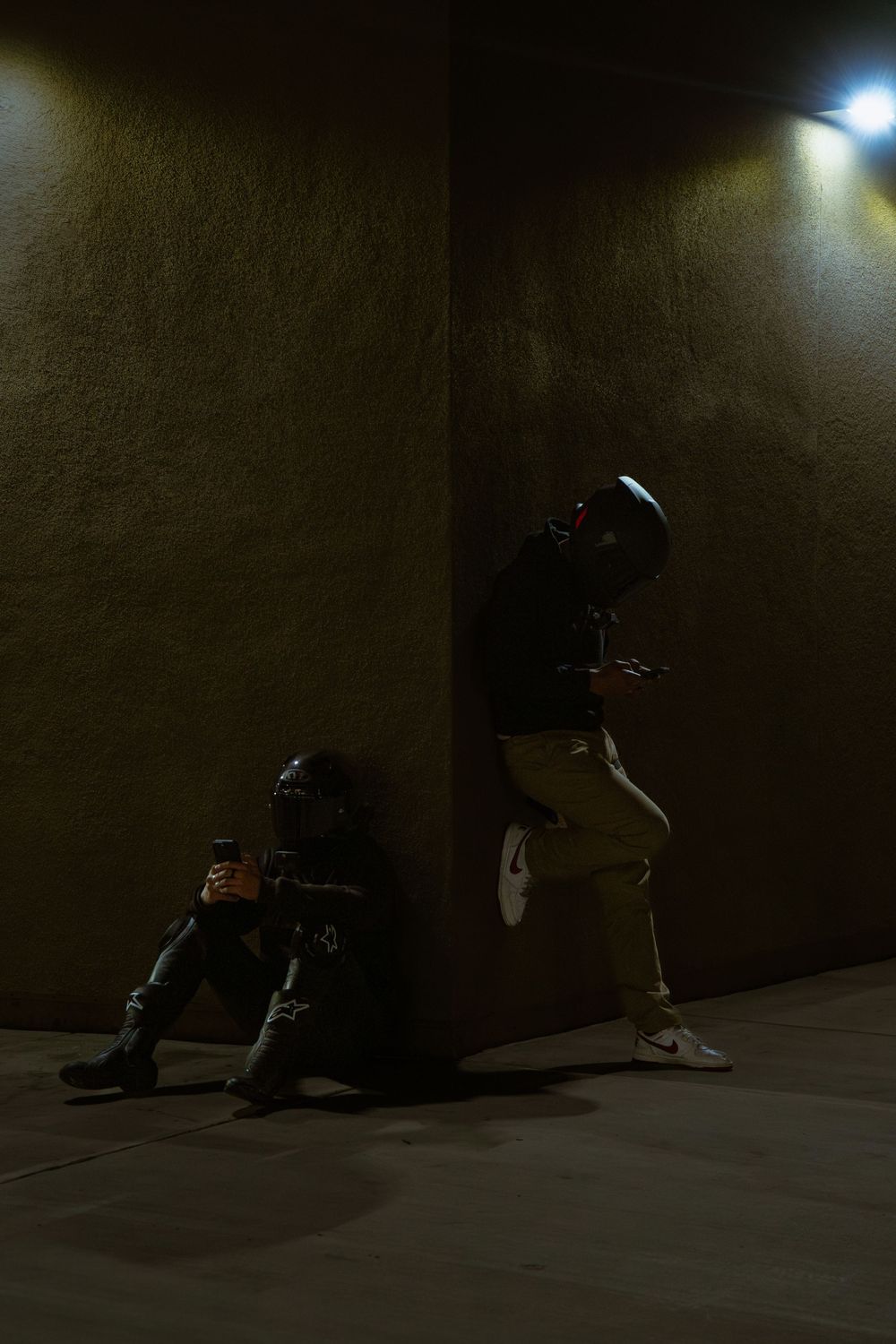 A dark, moody sequence showing a person sitting alone in a dimly lit corner, creating a sense of isolation and solitude.