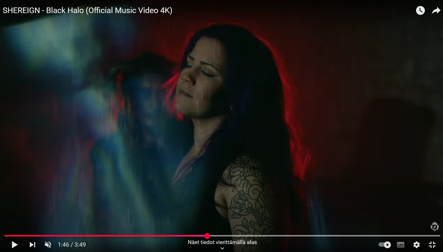 Atmospheric screenshot from a music video featuring soft lighting and red backlit effects.