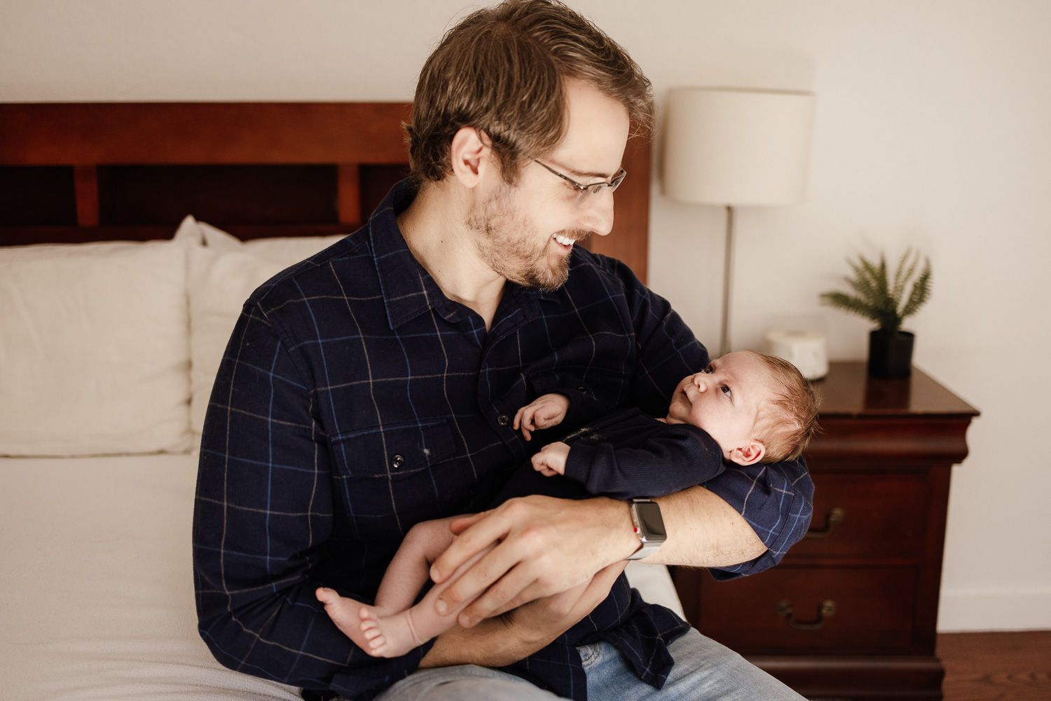 Dad holds his baby at in-home baby photography session in San Jose