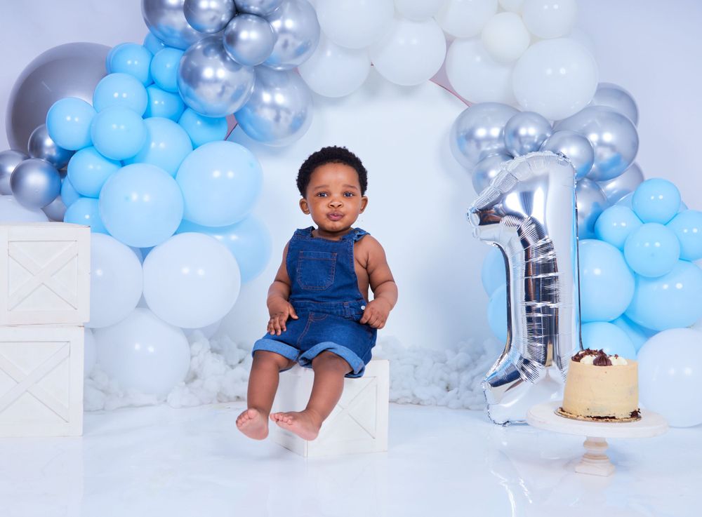 Professional photography studio with blue and silver balloon arrangements.