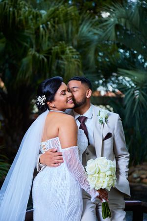Intimate wedding portraits captured in lush tropical garden setting.