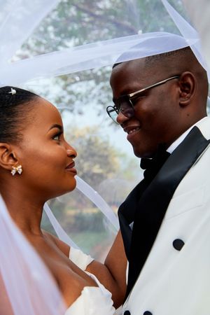 Artistic wedding portraits capture tender moments between newlyweds.