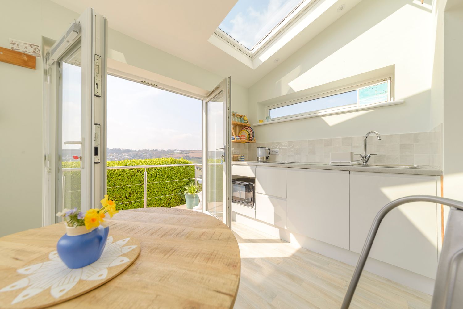 mevagisssey air bnb, kitchen view through patio door bathed in sunlight
