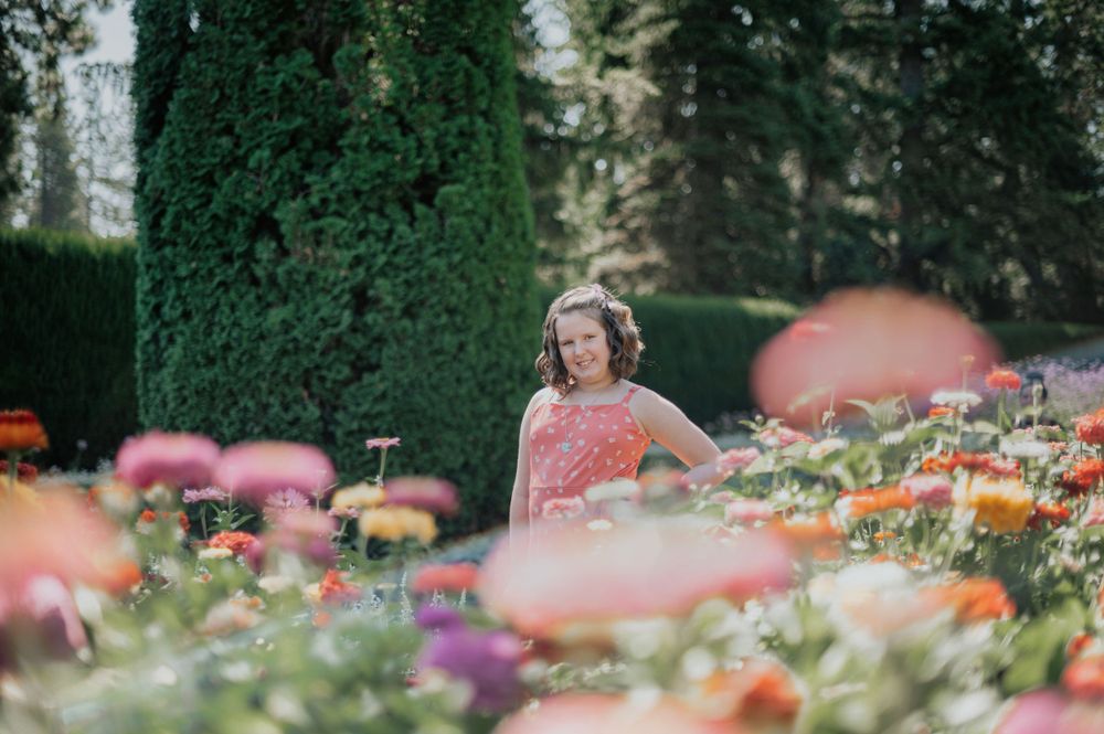 A portrait of a child in a flower garden in Manito Park in Spokane Washington taken by Jessica Rae Photography.