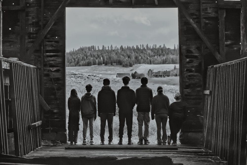 A silhouette of siblings taken in a barn in Spokane Washington by Jessica Rae Photography.