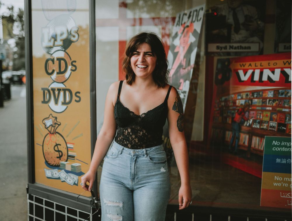 Young woman smiling outside a music store in Cincinnati