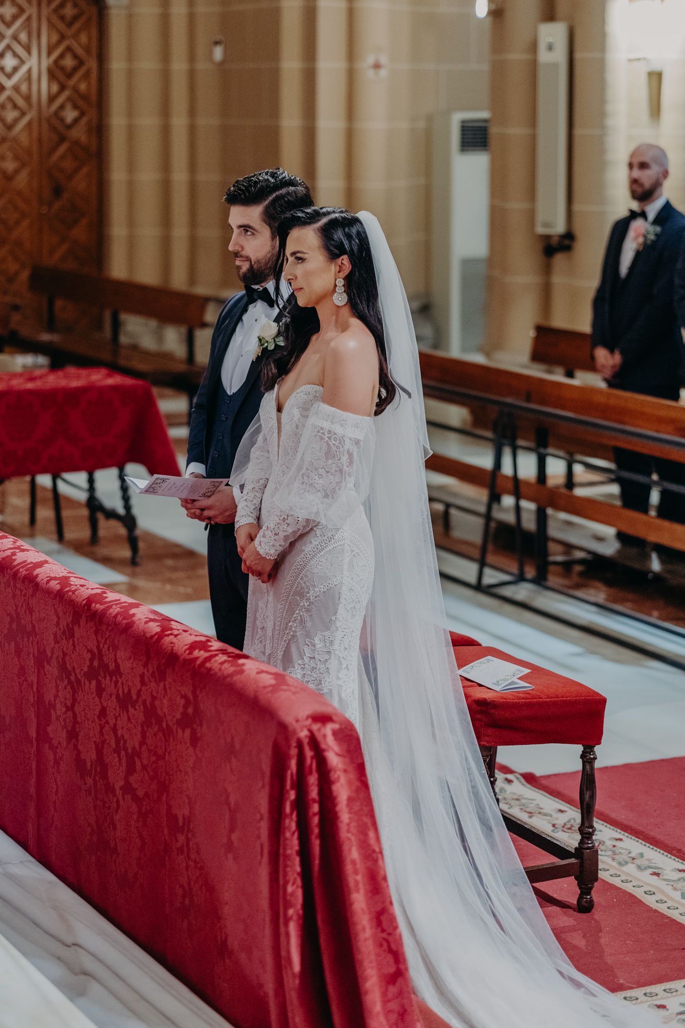 A bride and groom stand at the altar during their traditional church ceremony.