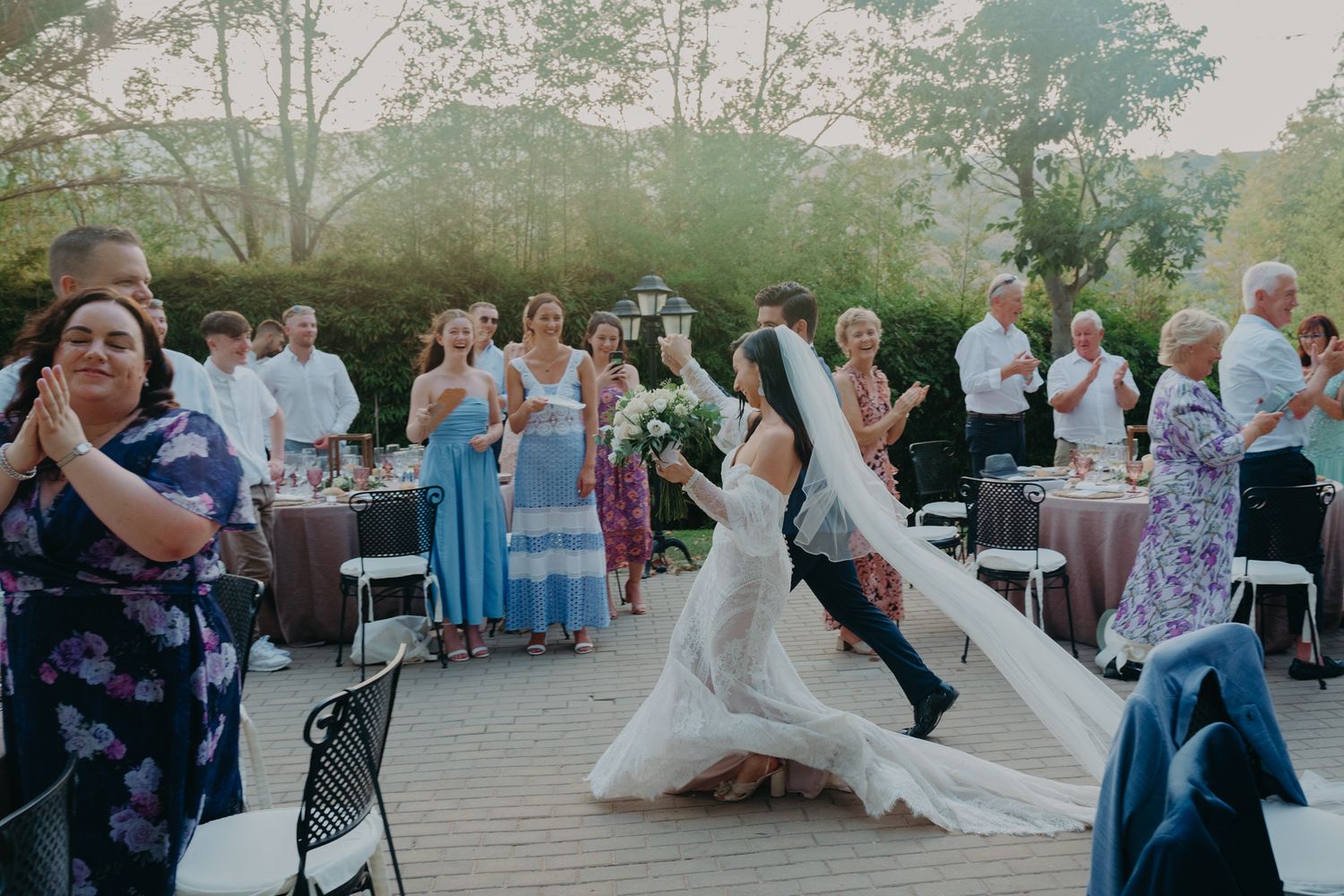 Wedding reception moment captured on outdoor deck with guests celebrating.