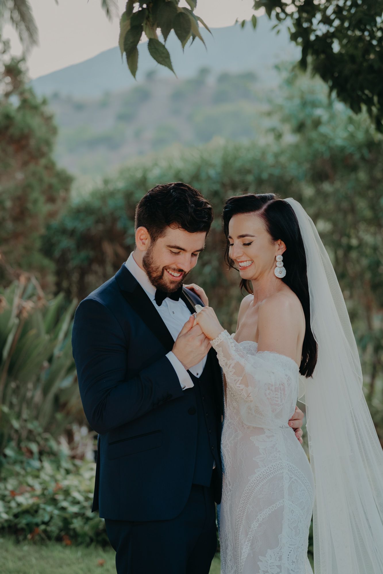 A tender wedding moment captured in a garden setting with a couple sharing an intimate embrace.
