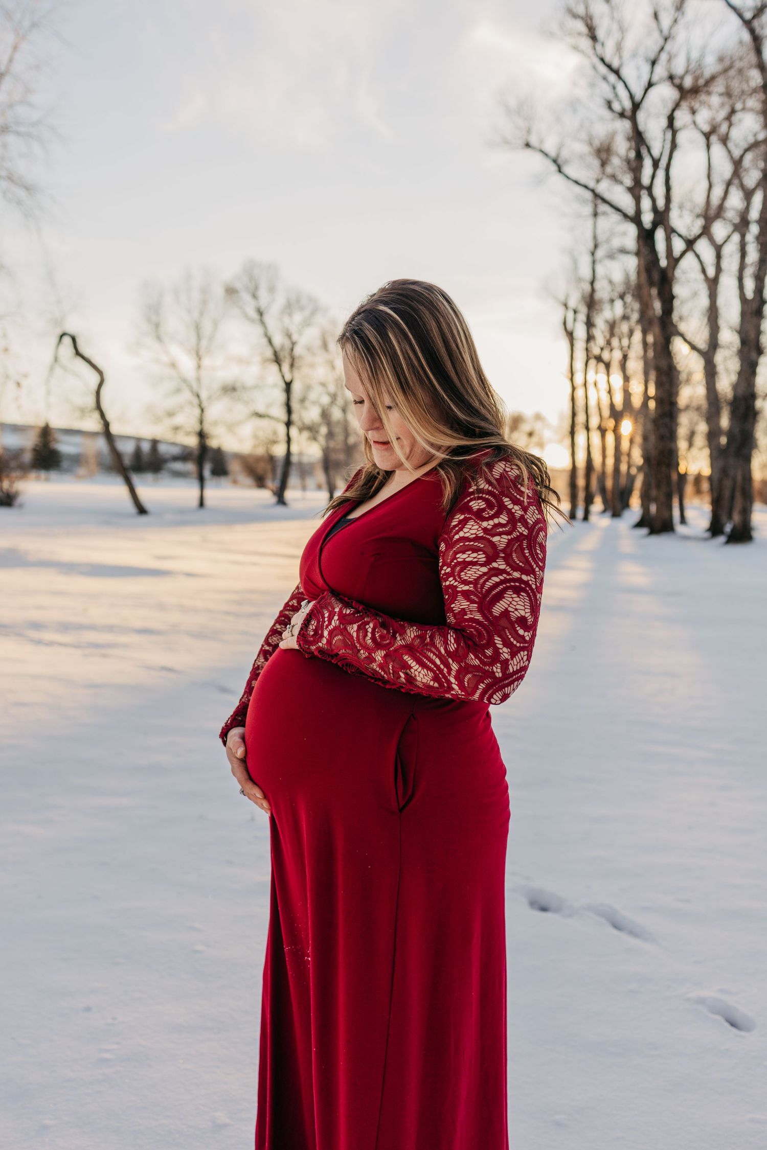 Milestone moment as parents to be stand side by side during this maternity session in a beautiful sunflower field.