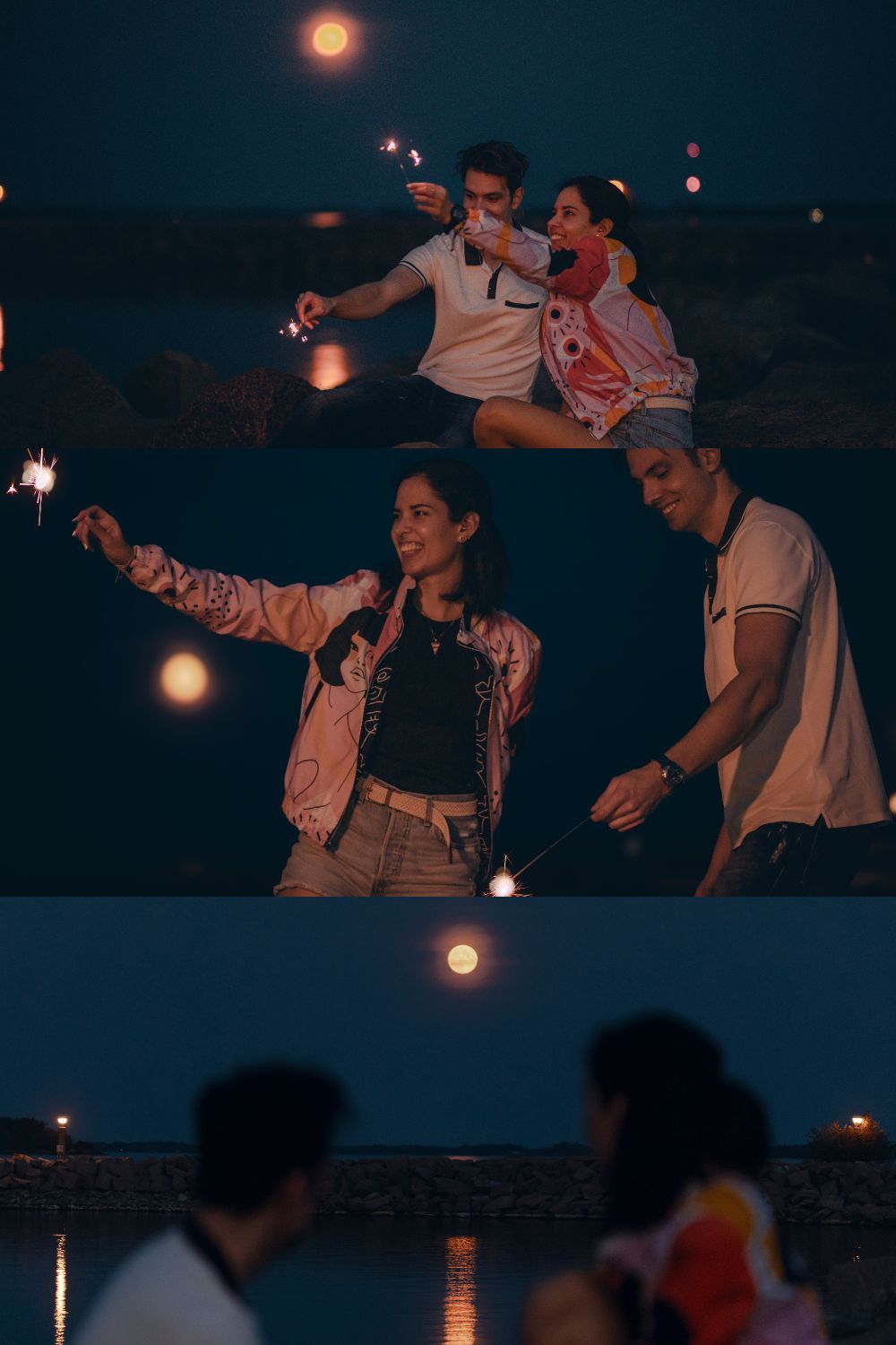 Couple laughing and holding sparklers on rocky shoreline during full moon, cinematic photoshoot in Kingston, Ontario. Lumenali Photography.