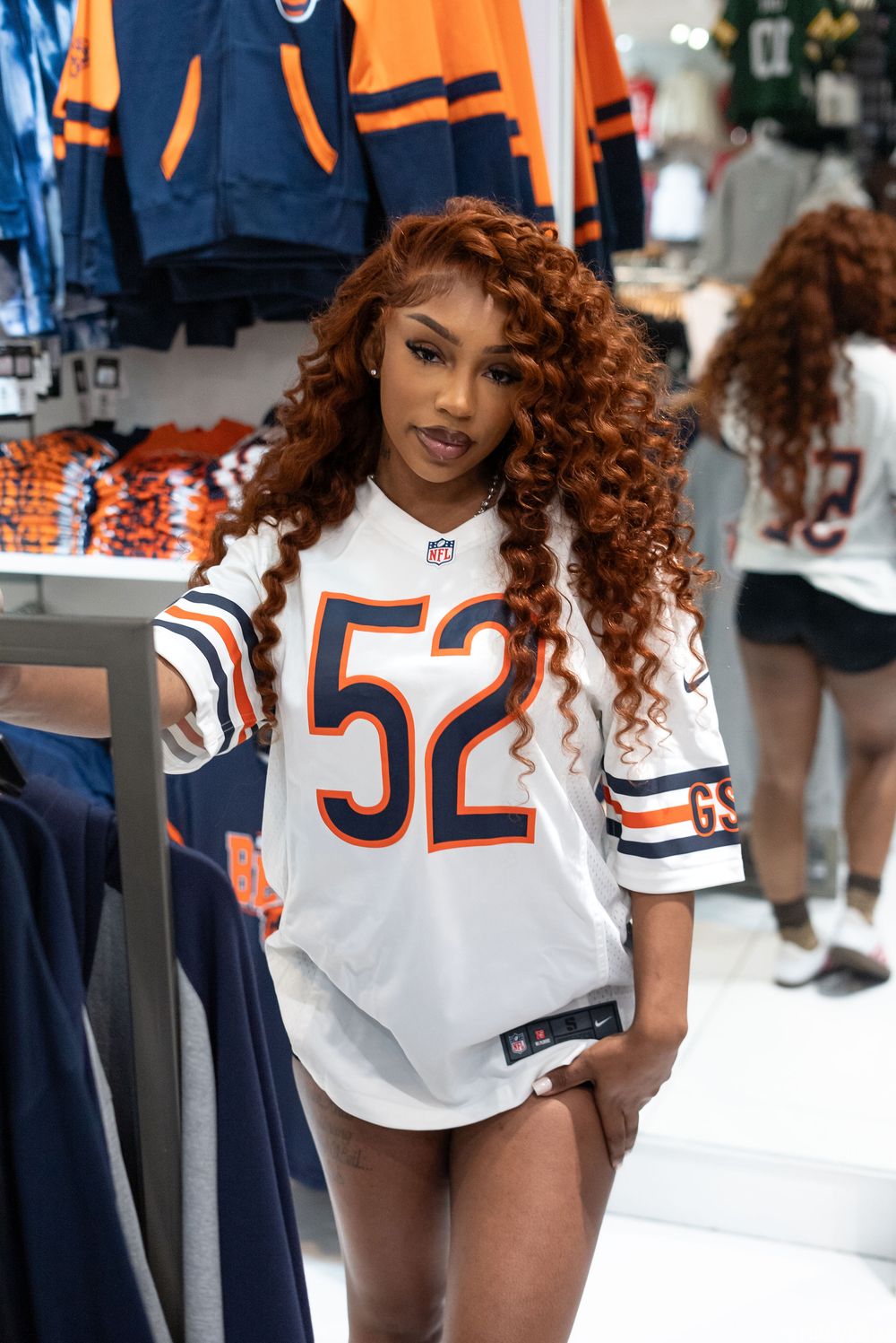 Model wearing Chicago Bears jersey poses in sports-themed photoshoot.