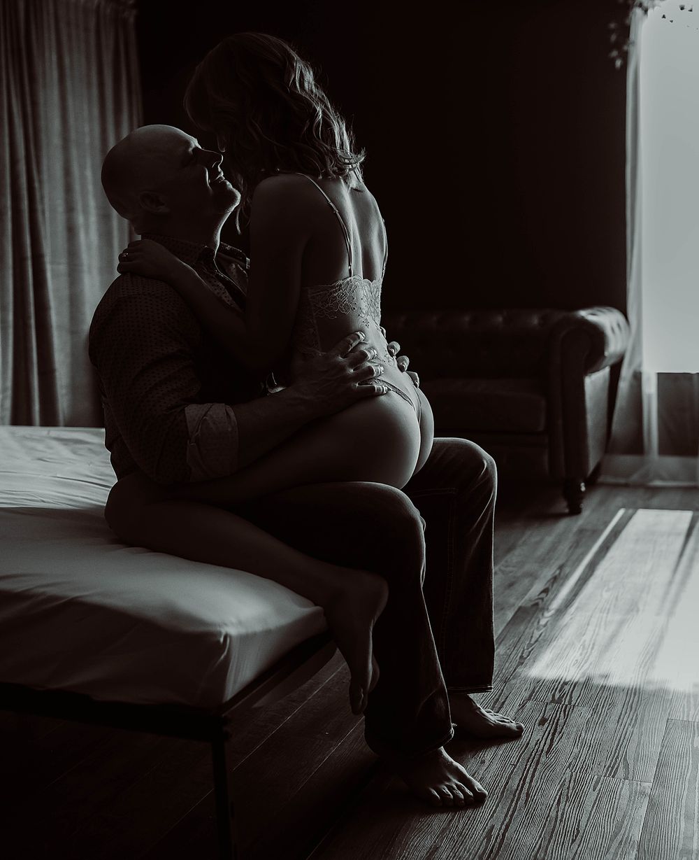 woman straddles her husband in their boudoir session for every season