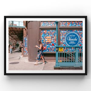 Person walks past storefront decorated with colorful butterfly patterns in an urban setting.