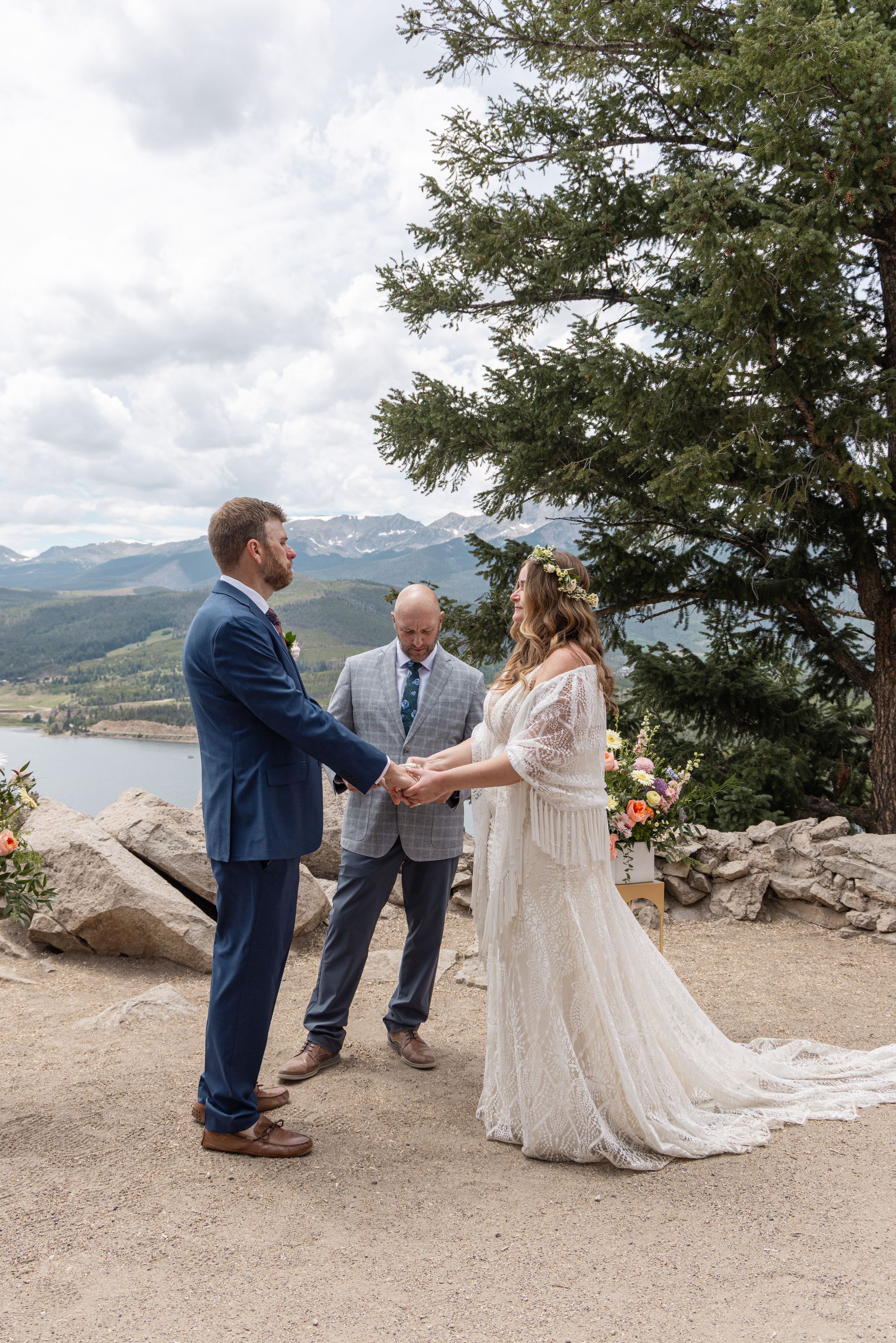 A couple has their first look during an intimate mountain elopement ceremony overlooking dramatic mountain vistas.