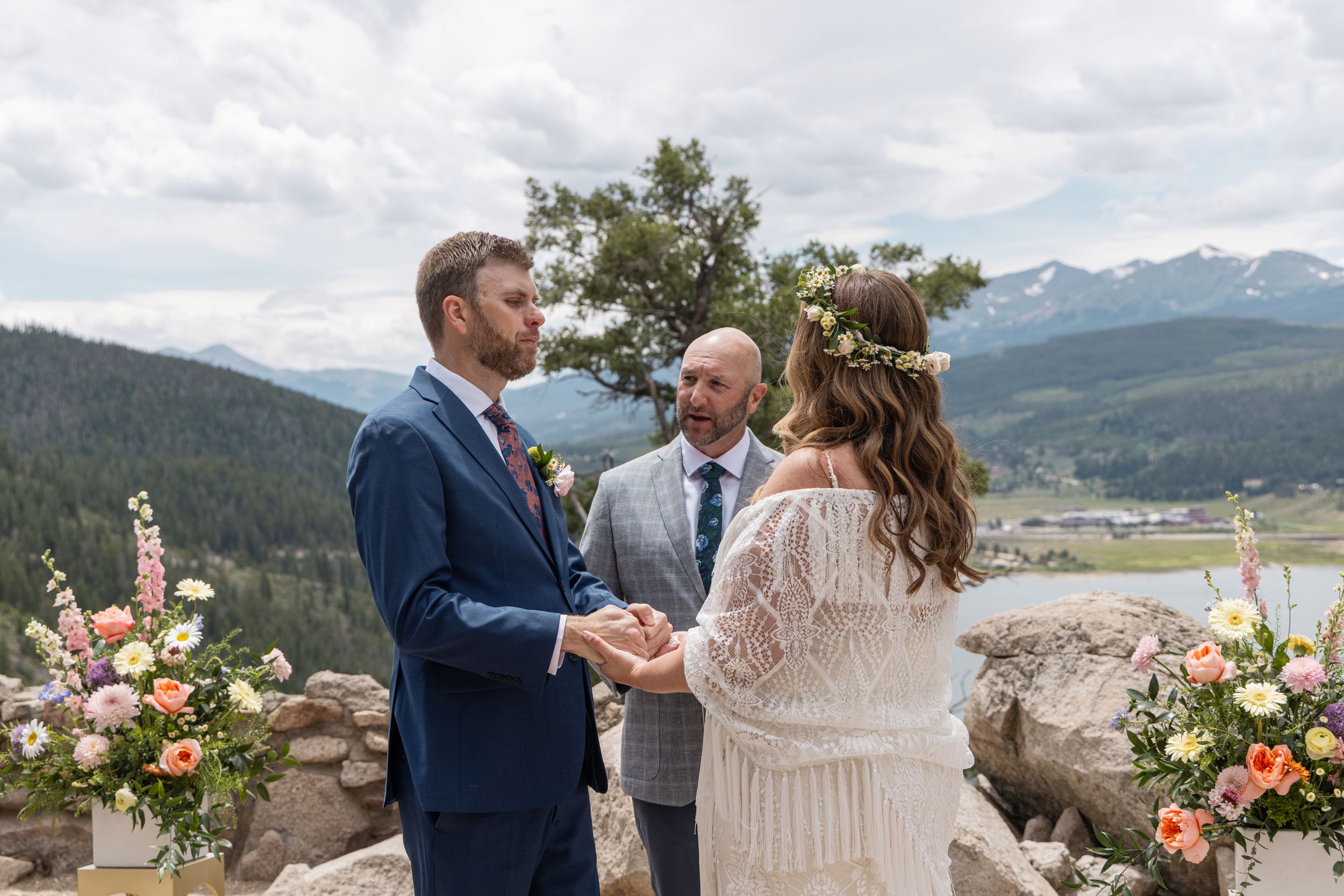 Wedding ceremony takes place at Sapphire Point overlook in Colorado with mountain views and floral arrangements.