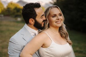 A happy couple shares a romantic moment outdoors during golden hour in a fall setting.
