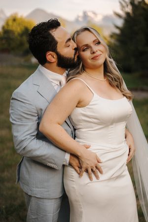 Intimate maternity photo series showing tender moments shared between an expectant couple in outdoor natural setting.