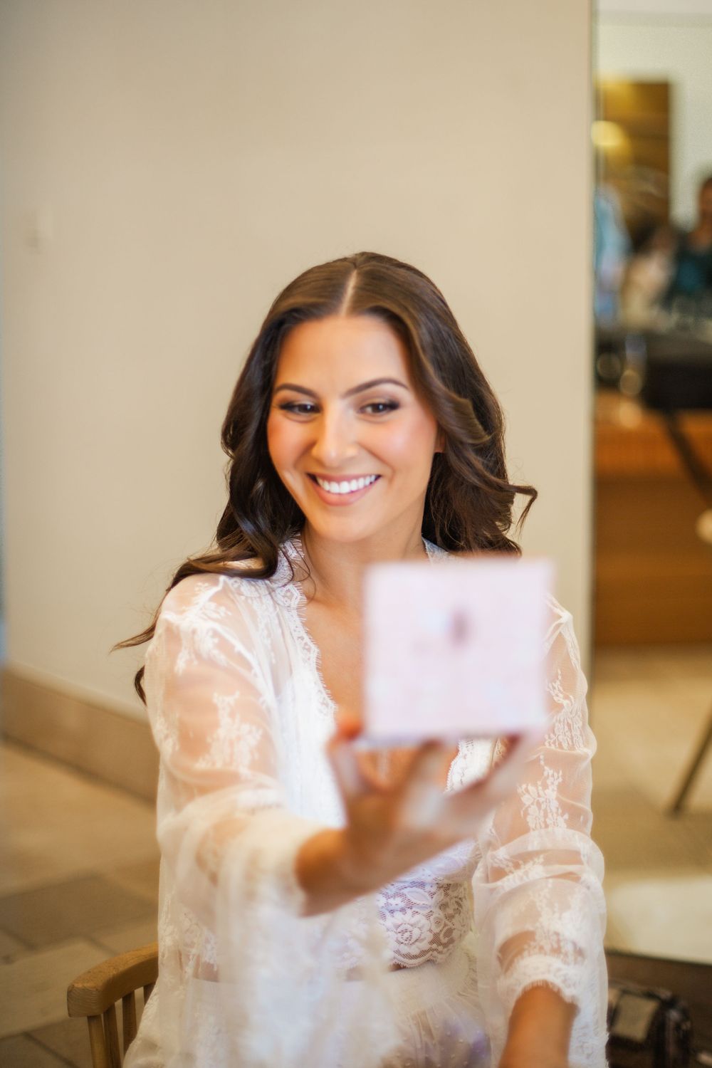 A bride in a romantic veil smiles and shows different poses in a series of wedding day portrait shots.
