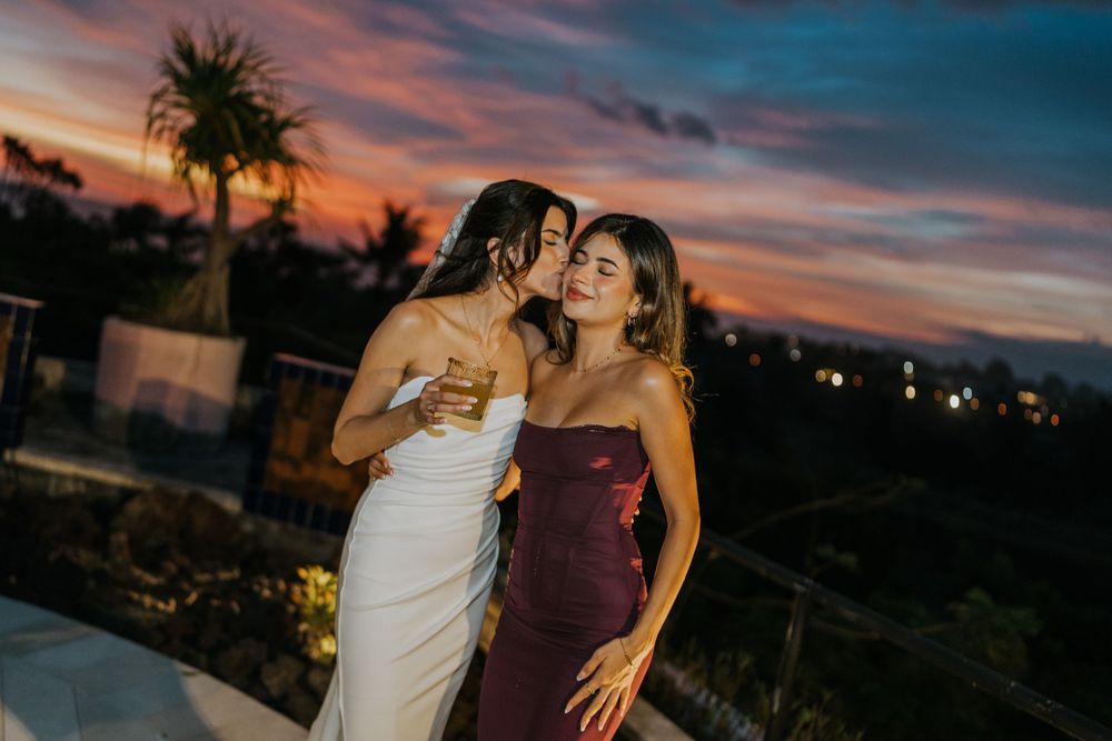 Beautiful sunset sky creates a dramatic backdrop for a wedding celebration.