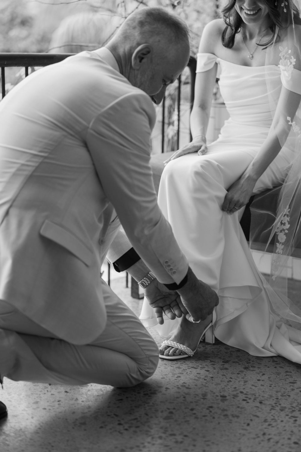 Close-up of playful interaction on textured ground in formal attire.