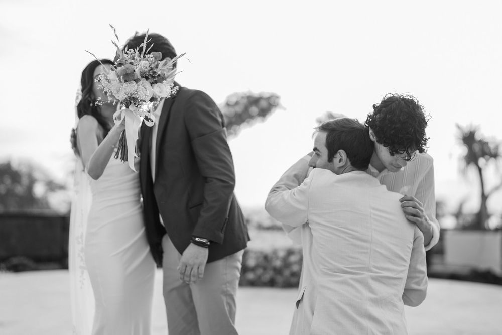 Black and white wedding photographs showing tender moments during the ceremony.