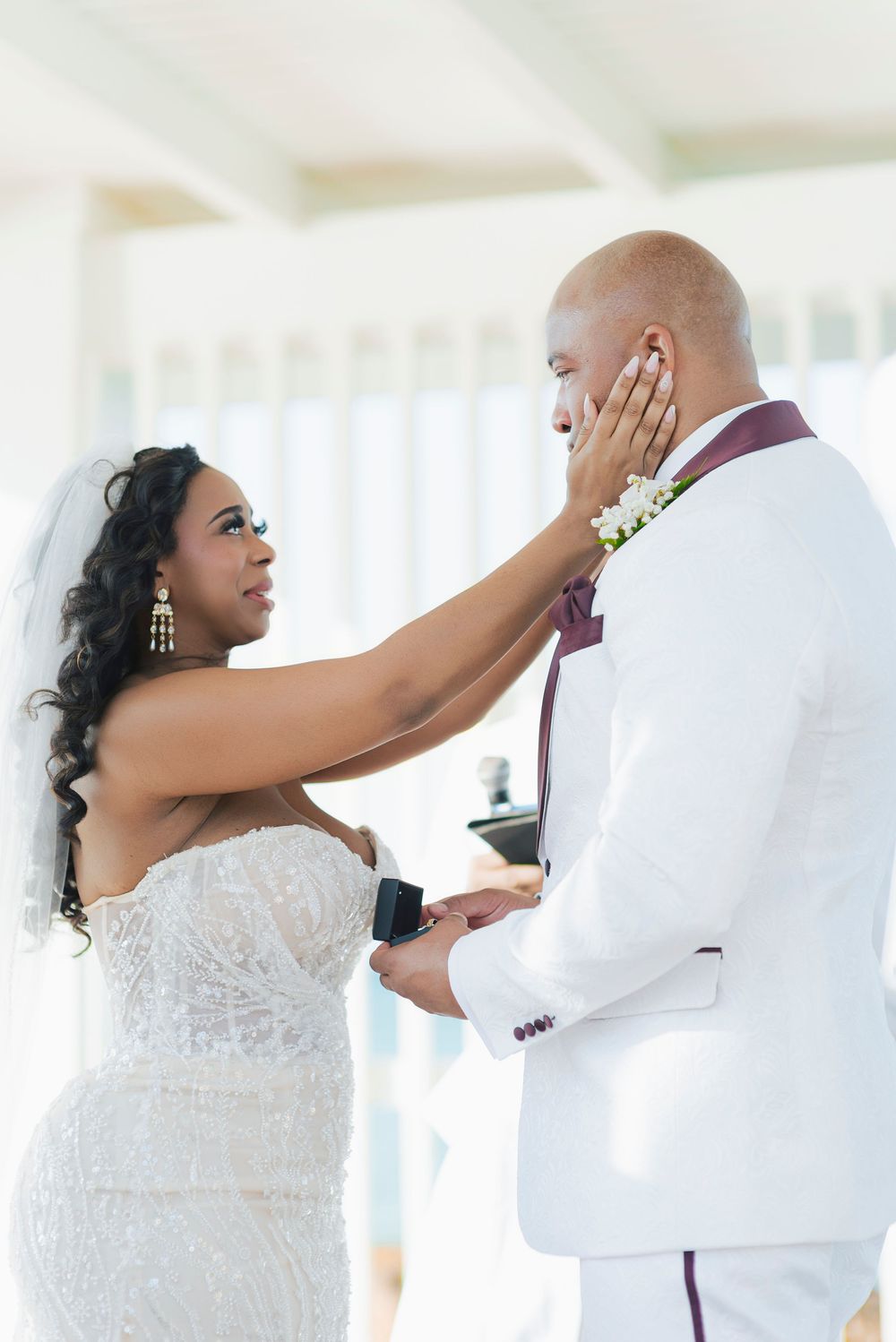 Sequence showing a romantic first look moment between bride and groom at a beach wedding.