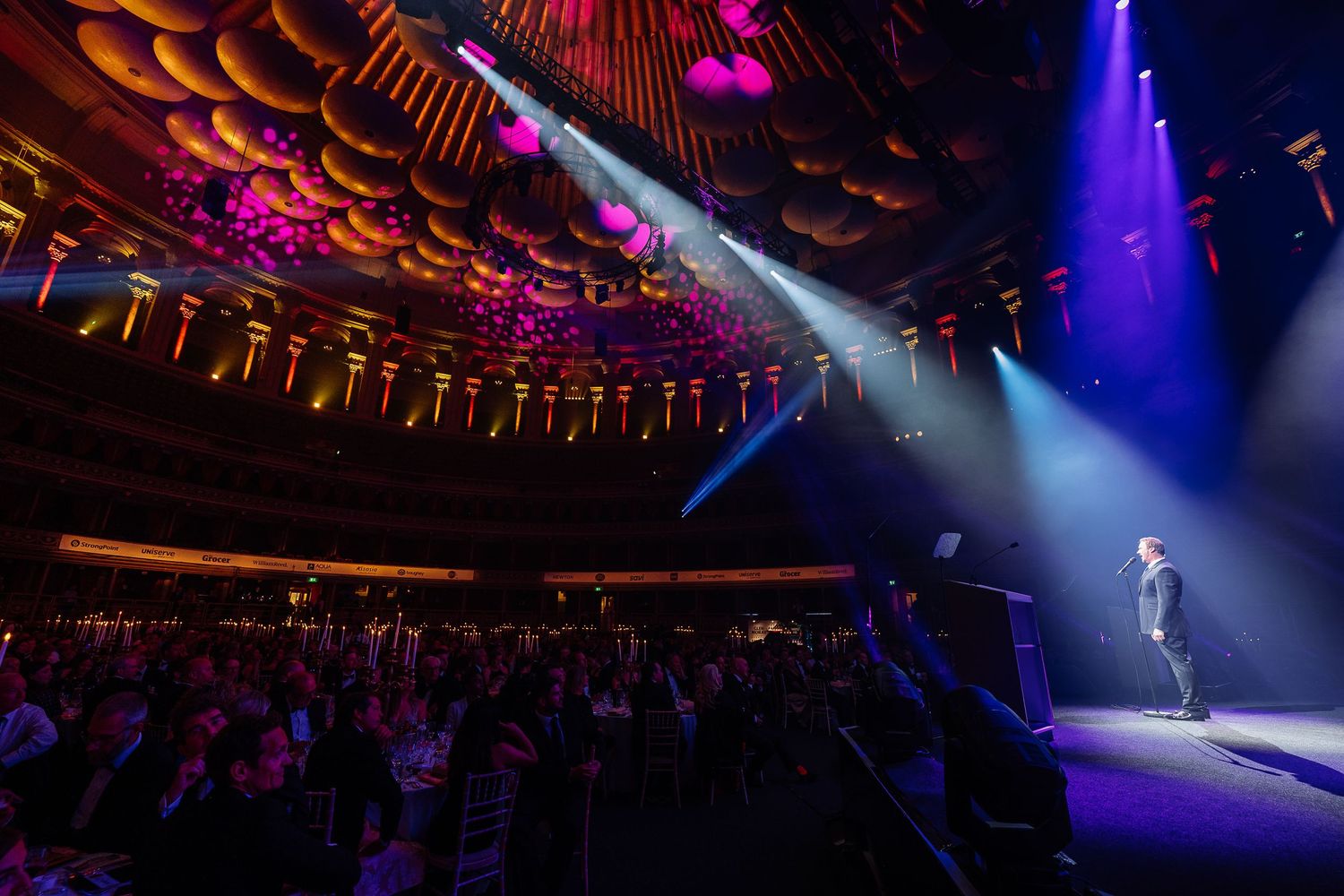 Concert hall with dramatic stage lighting and theatrical performance setup.