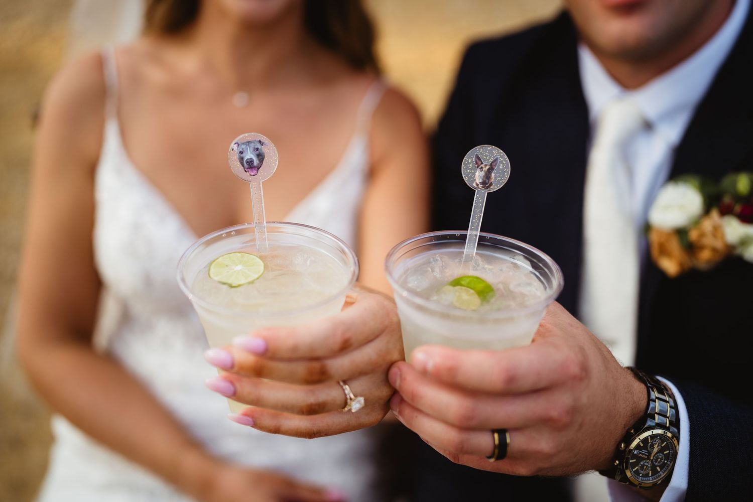 Wedding guests holding pink milkshake cocktails in mason jars with whipped cream and straws.