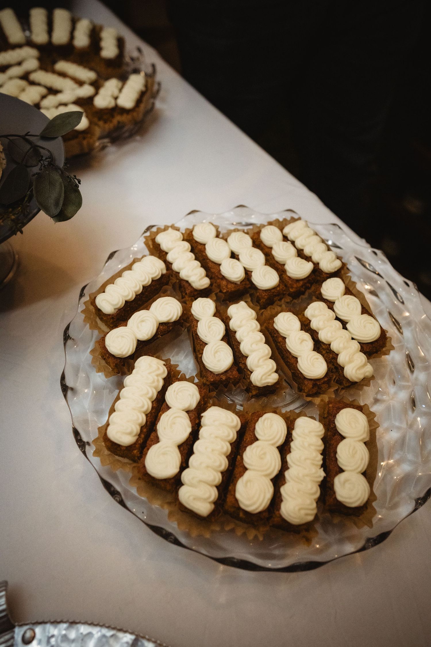 Multiple gourmet chocolate-covered Oreo cookies arranged in rows on a decorative glass serving platter.