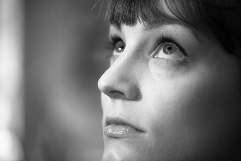 Artistic black and white profile portrait with dramatic lighting.
