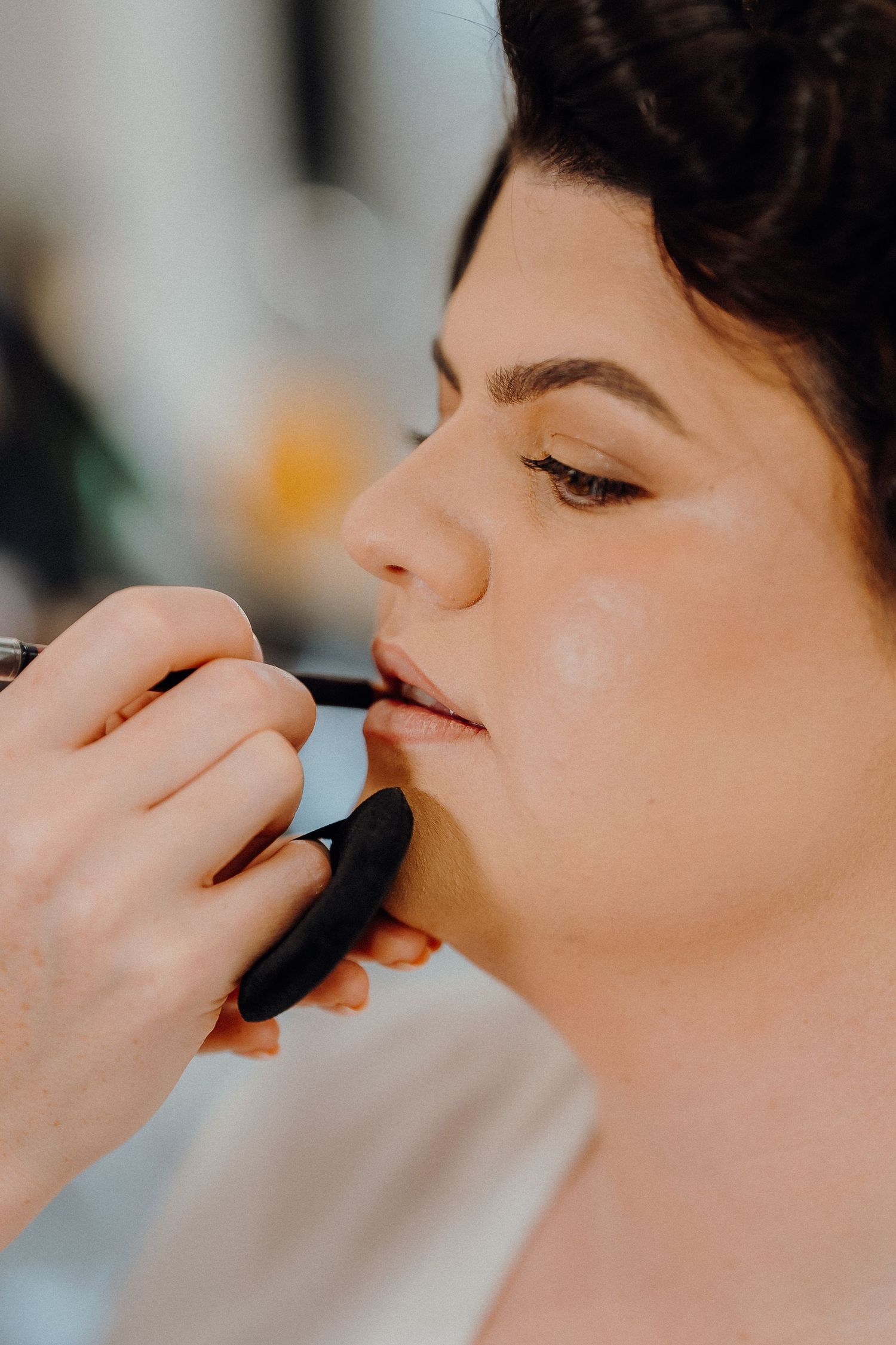 Professional makeup artist applying mascara to a client's eyelashes in a series of closeup shots.