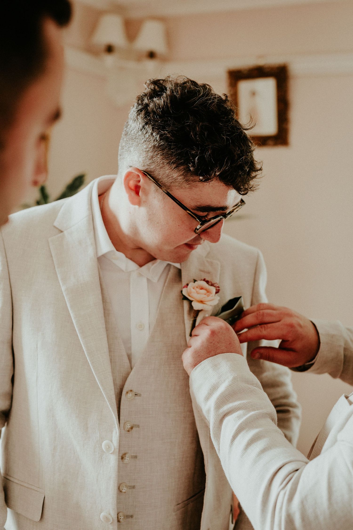 A sequence of photos showing someone adjusting their white formal attire and bowtie.