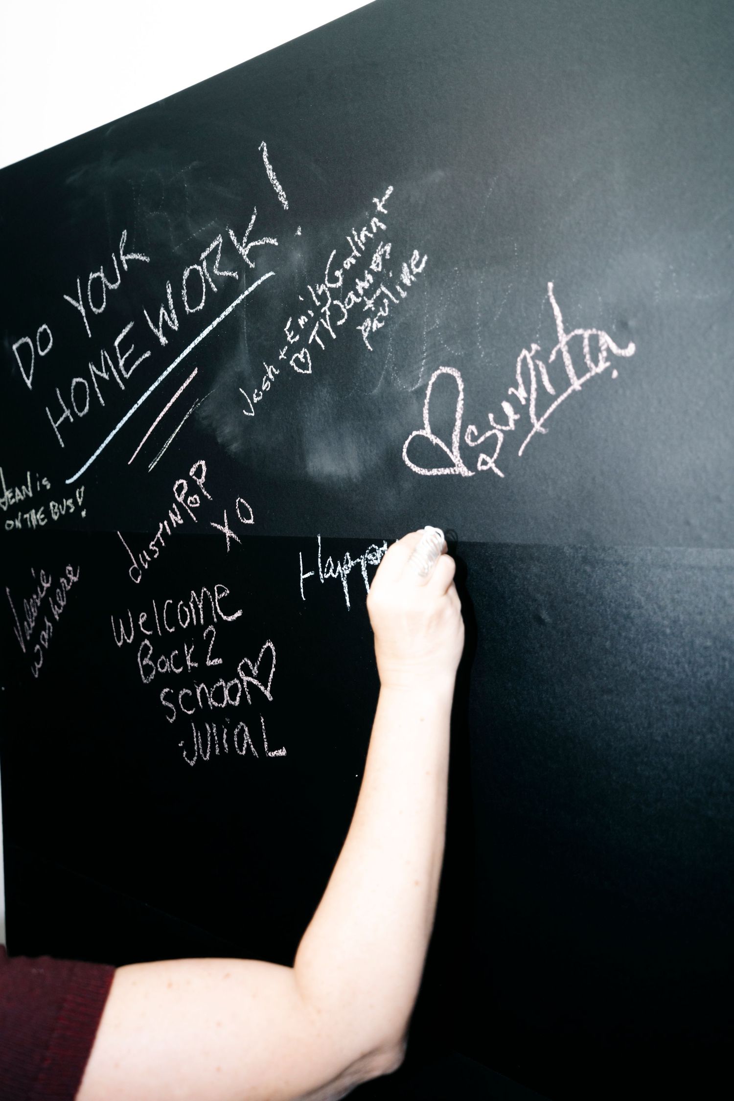 Close-up shots of white chalk writing appearing on a black chalkboard surface.