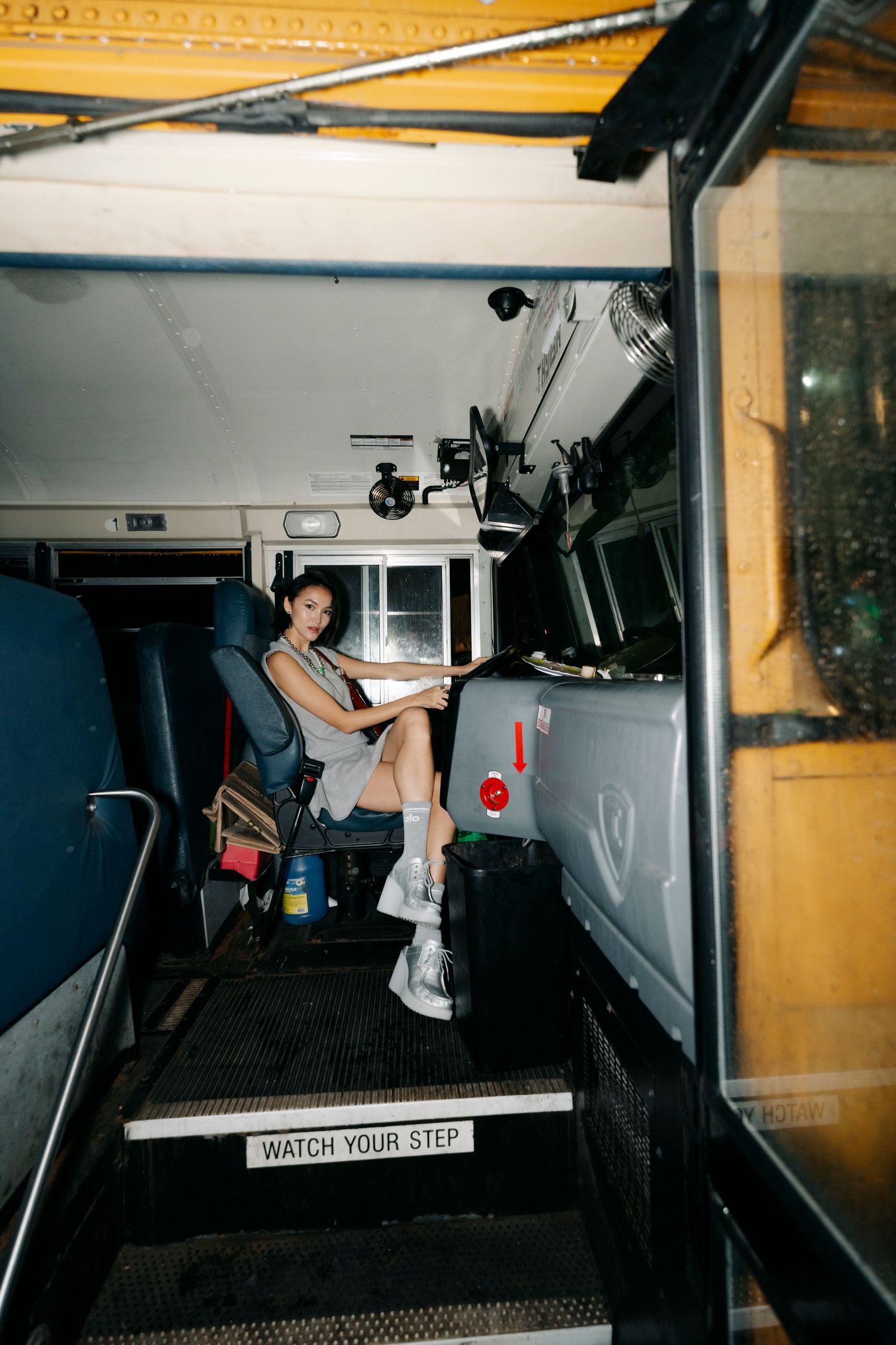 Interior shots of a dimly lit bus with people climbing and posing inside.