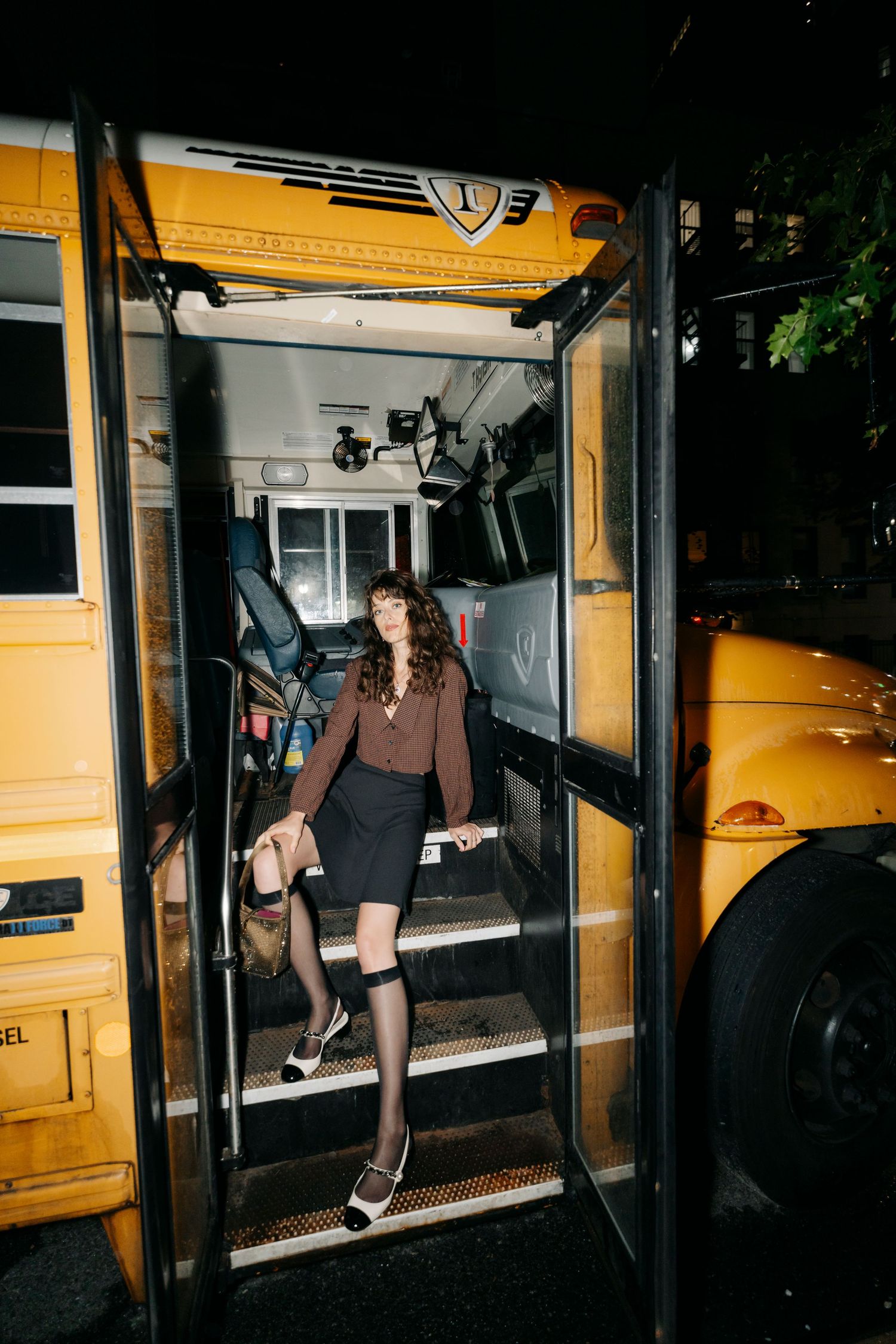 Nighttime party scenes around a yellow school bus with dramatic lighting.
