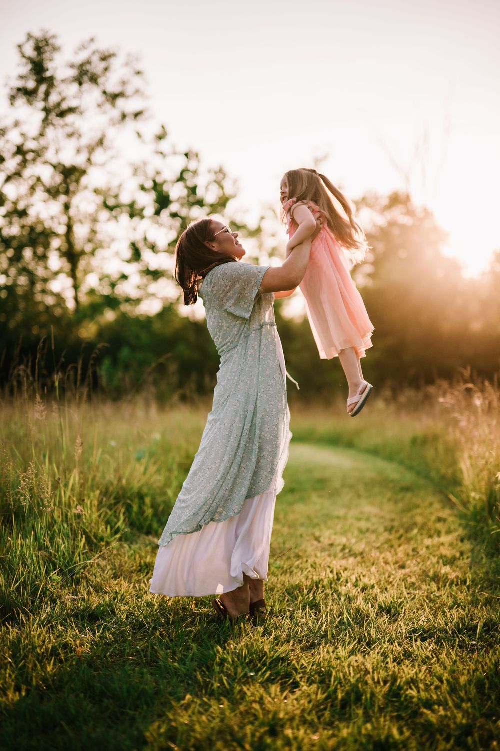Playful moments captured in golden evening light during outdoor family photography.