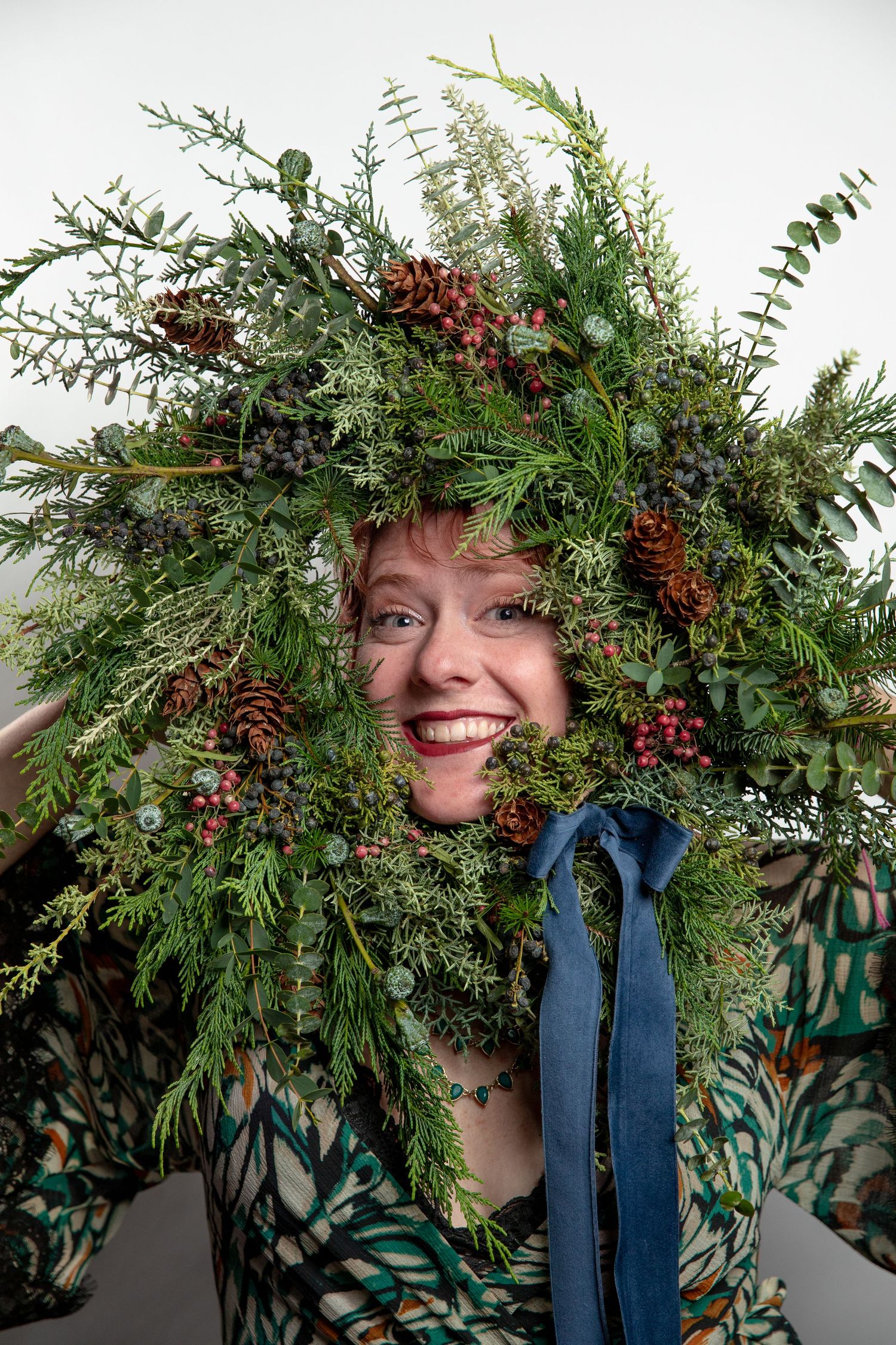 Decorative winter wreath made with fresh evergreen branches and pinecones.