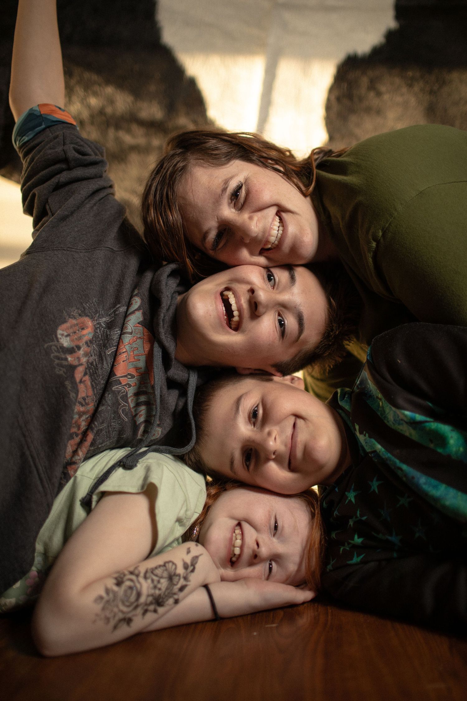 Warm intimate portrait in natural lighting on wooden floor.