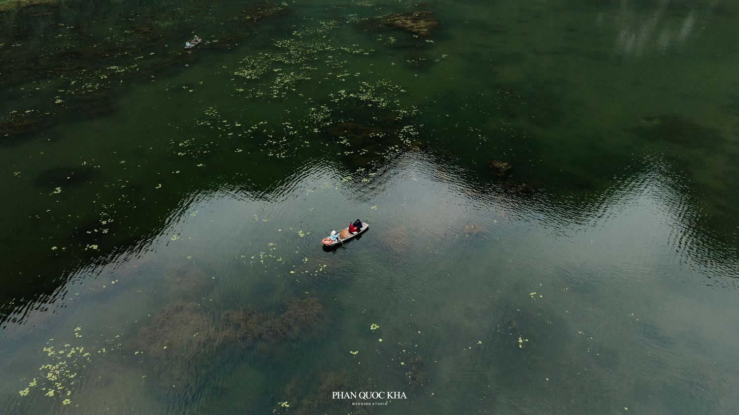 Drone shot of Chrish & Jenny standing in the middle of rice fields in Ninh Binh