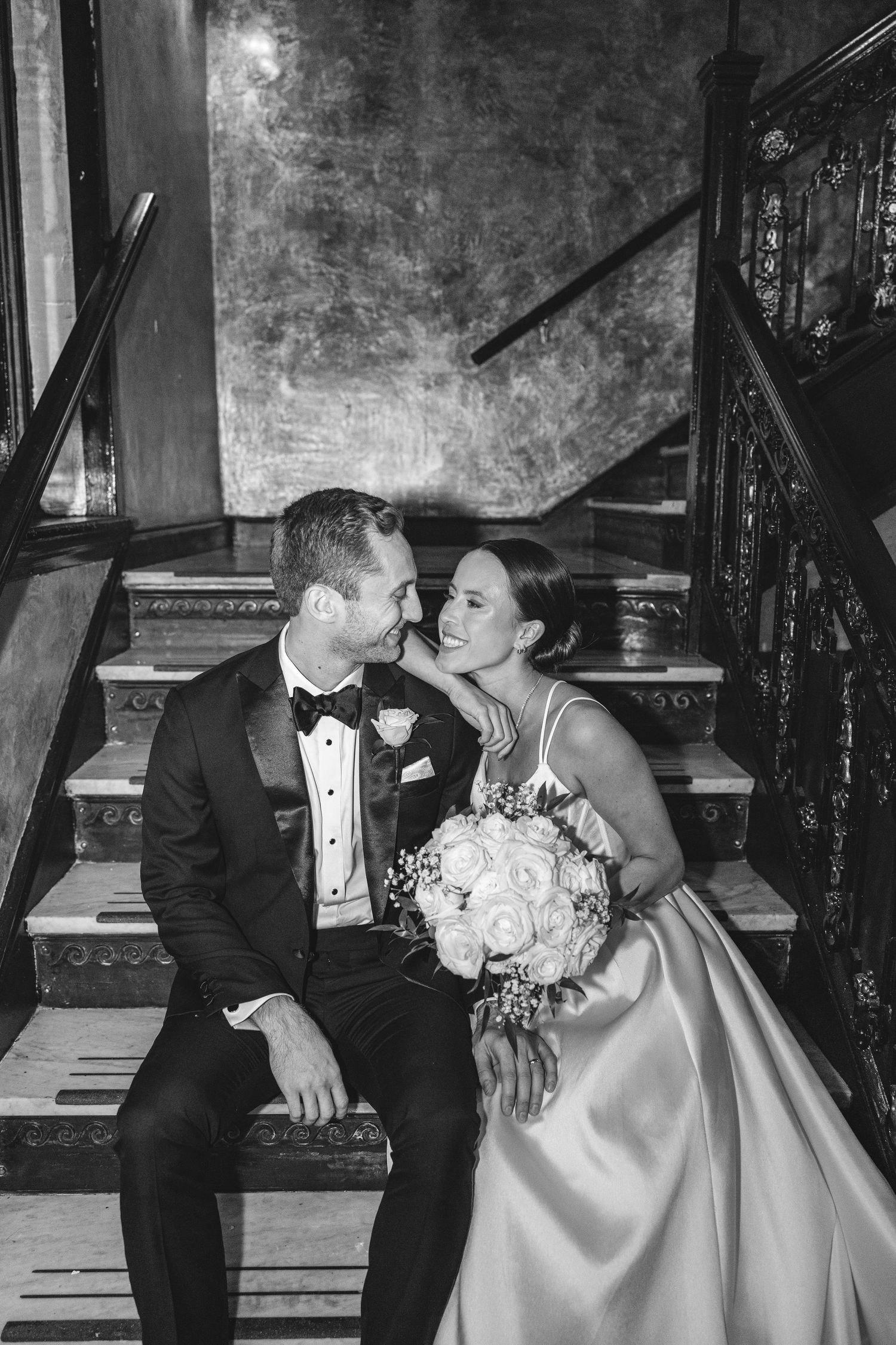 A loving couple shares tender kisses in their formal wedding attire, shown in multiple black and white photographs.