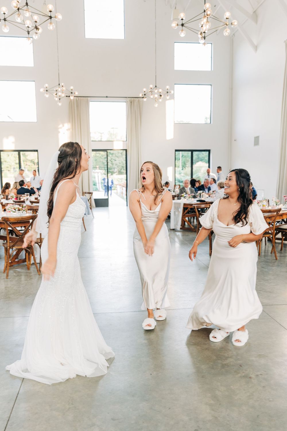 A sequence of photos showing a bride dancing and twirling in a white wedding dress in a bright modern venue.