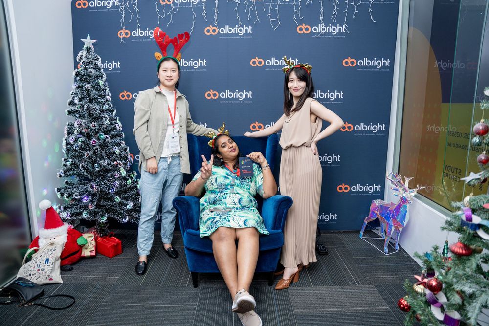 Holiday decorations and branding backdrop setup for a corporate event.