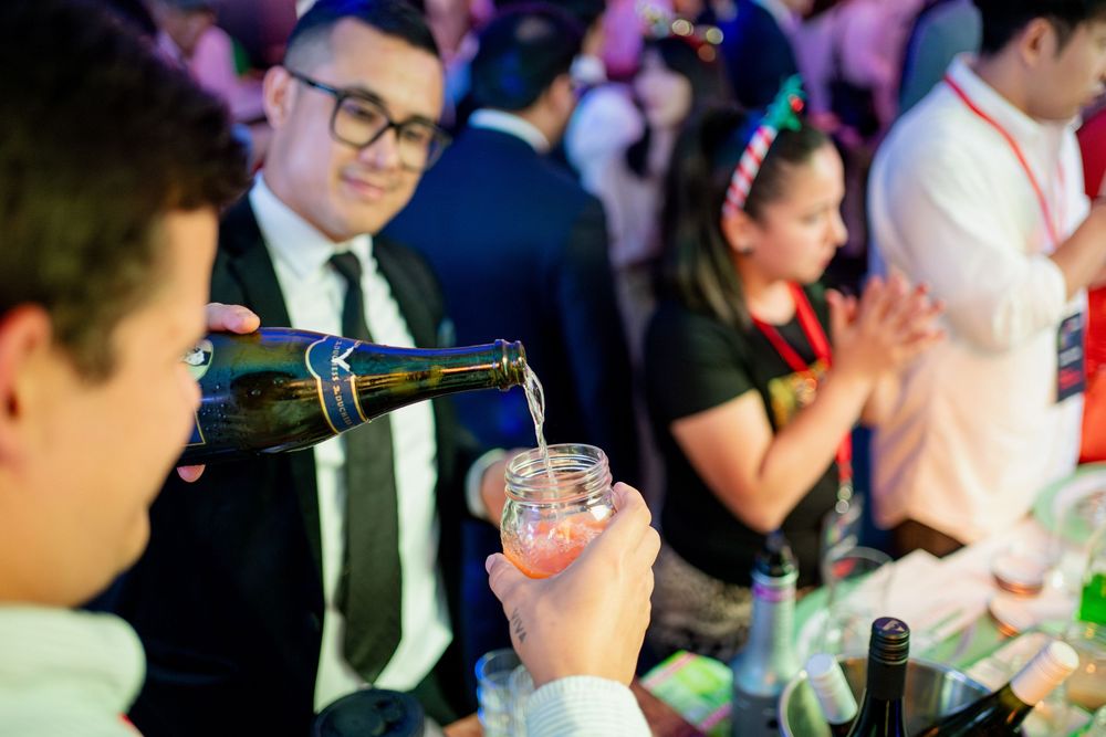 Event guests mingling at a corporate function with ambient lighting.